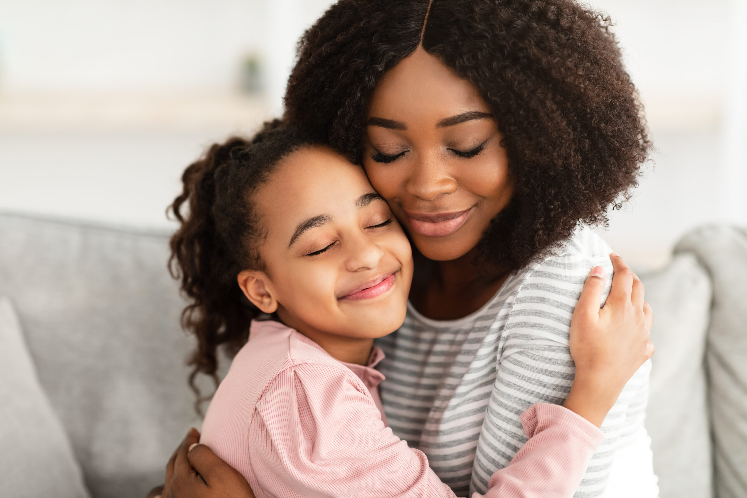 A mother and daughter sharing a peaceful, loving embrace, representing the grace and rest of the vocation of a mother.