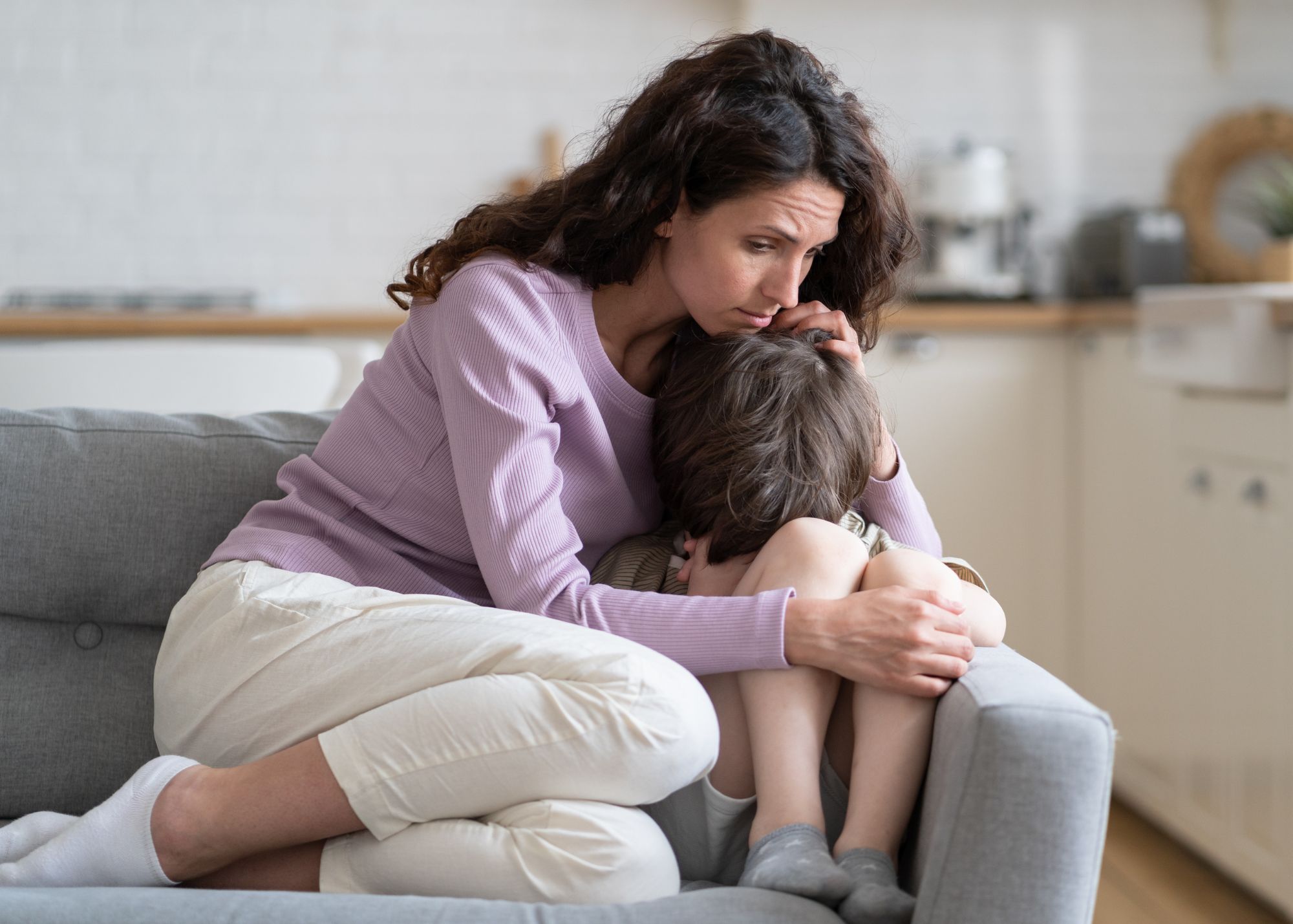 Mother comforting anxious child on couch—Christian homeschool Gospel of Limits grace for “I can’t” moments.