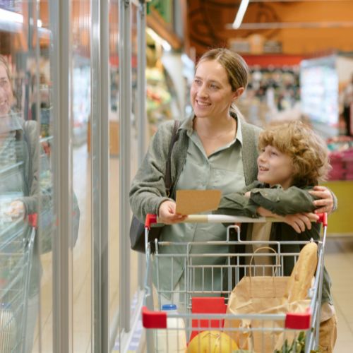 Homeschool socialization through real life as a mother and child talk together while shopping at the grocery store.