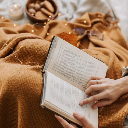 A homeschool mother reading quietly at the beginning of a new year, choosing rest and reflection over urgency